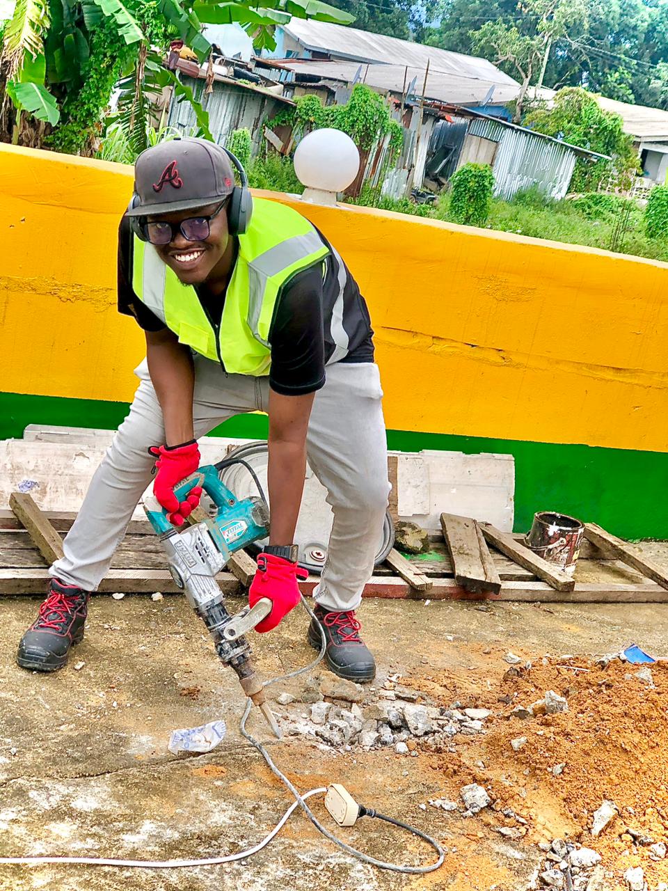 Female Hadi Technologies engineer in hi-vis vest using a concrete breaker